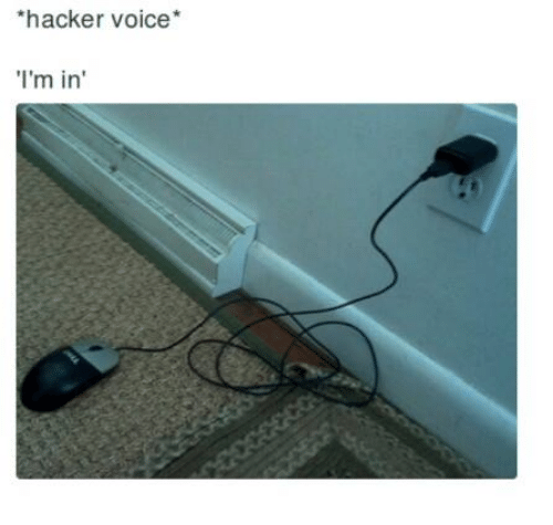 &ldquo;hacker voice: I&rsquo;m in&rdquo; meme showing a mouse cable plugged into a wall power outlet